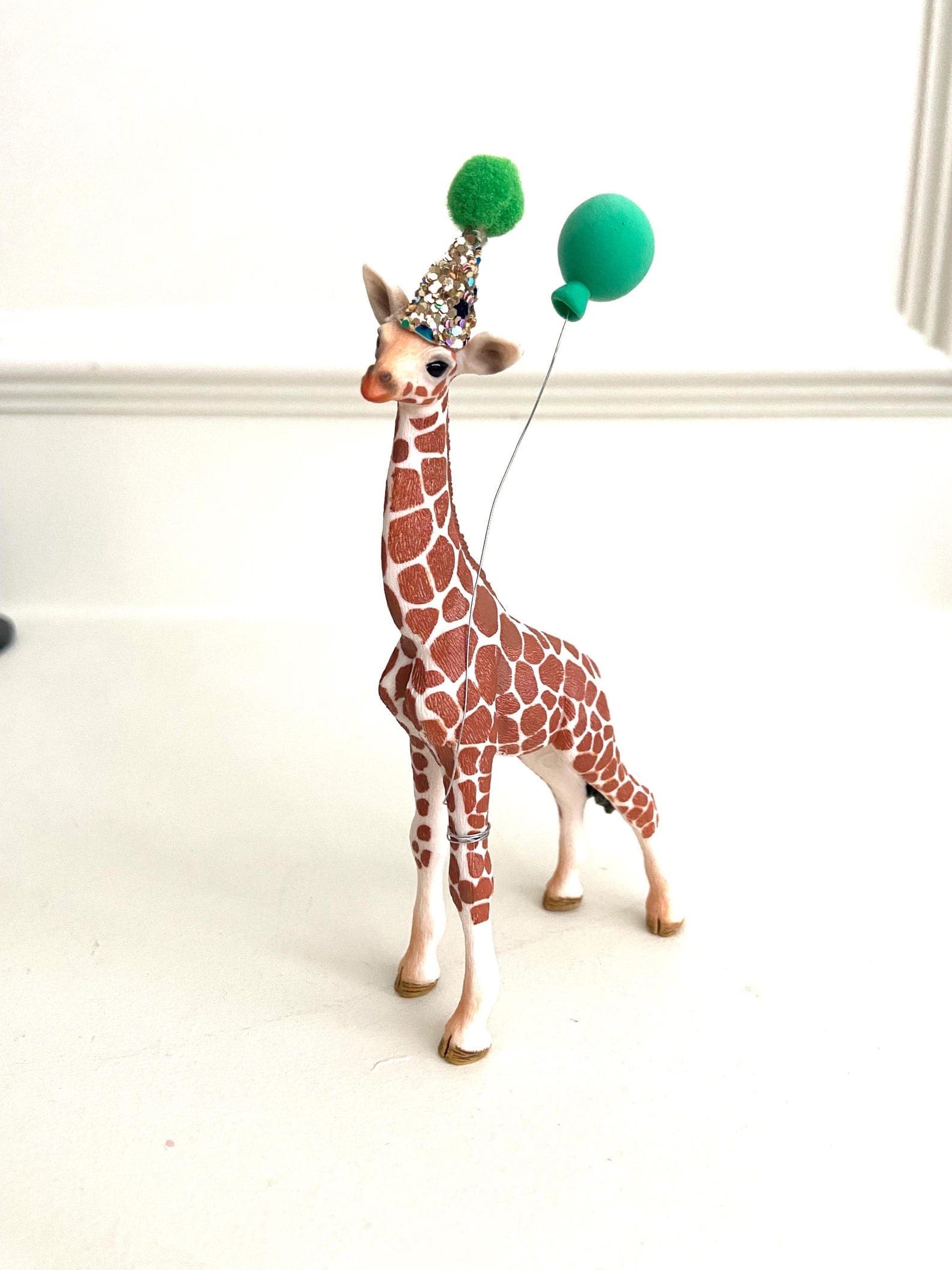 Mini giraffe cake topper with handmade glitter party hat